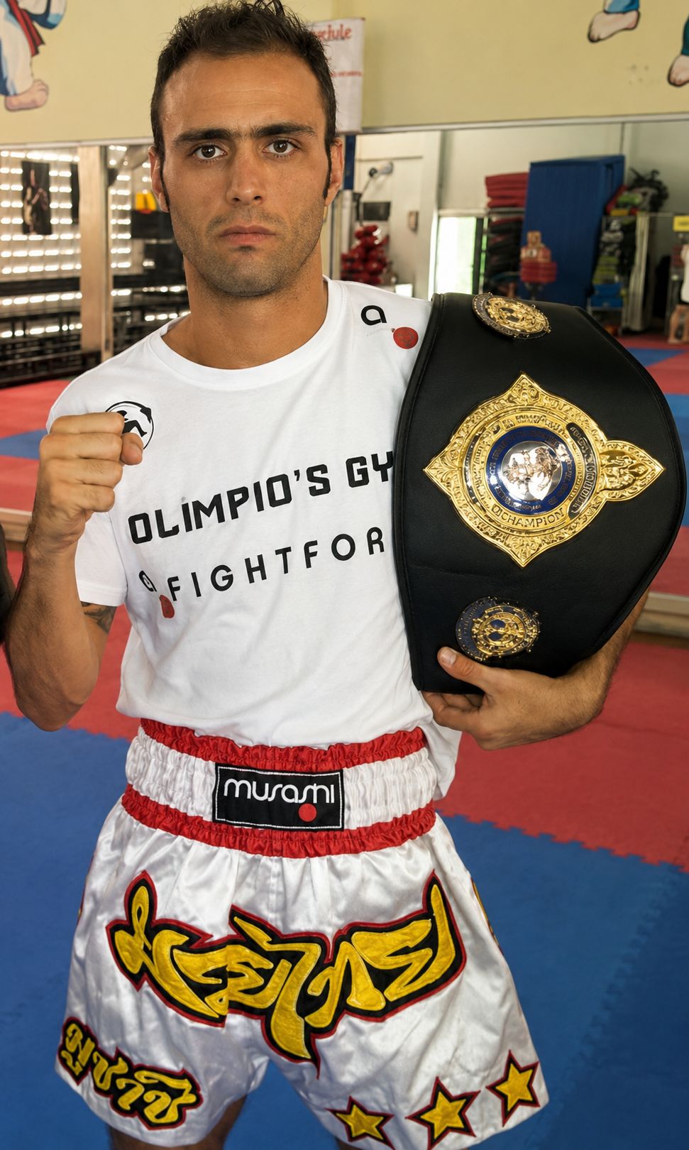 Fred Motta — Muay Thai World Champion 2013, holding championship belt