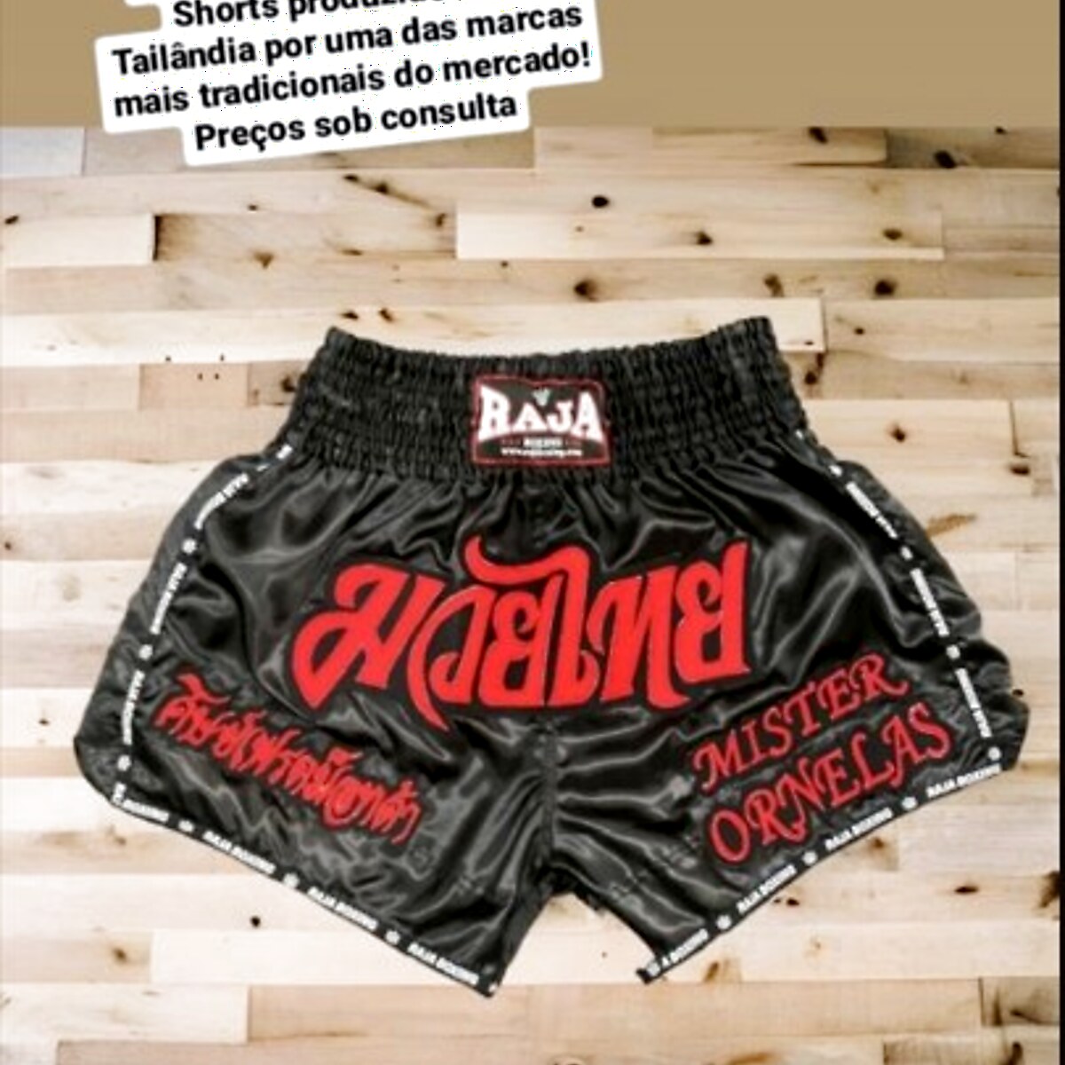 RAJA custom Muay Thai shorts — black satin with mirrored Muay Thai script